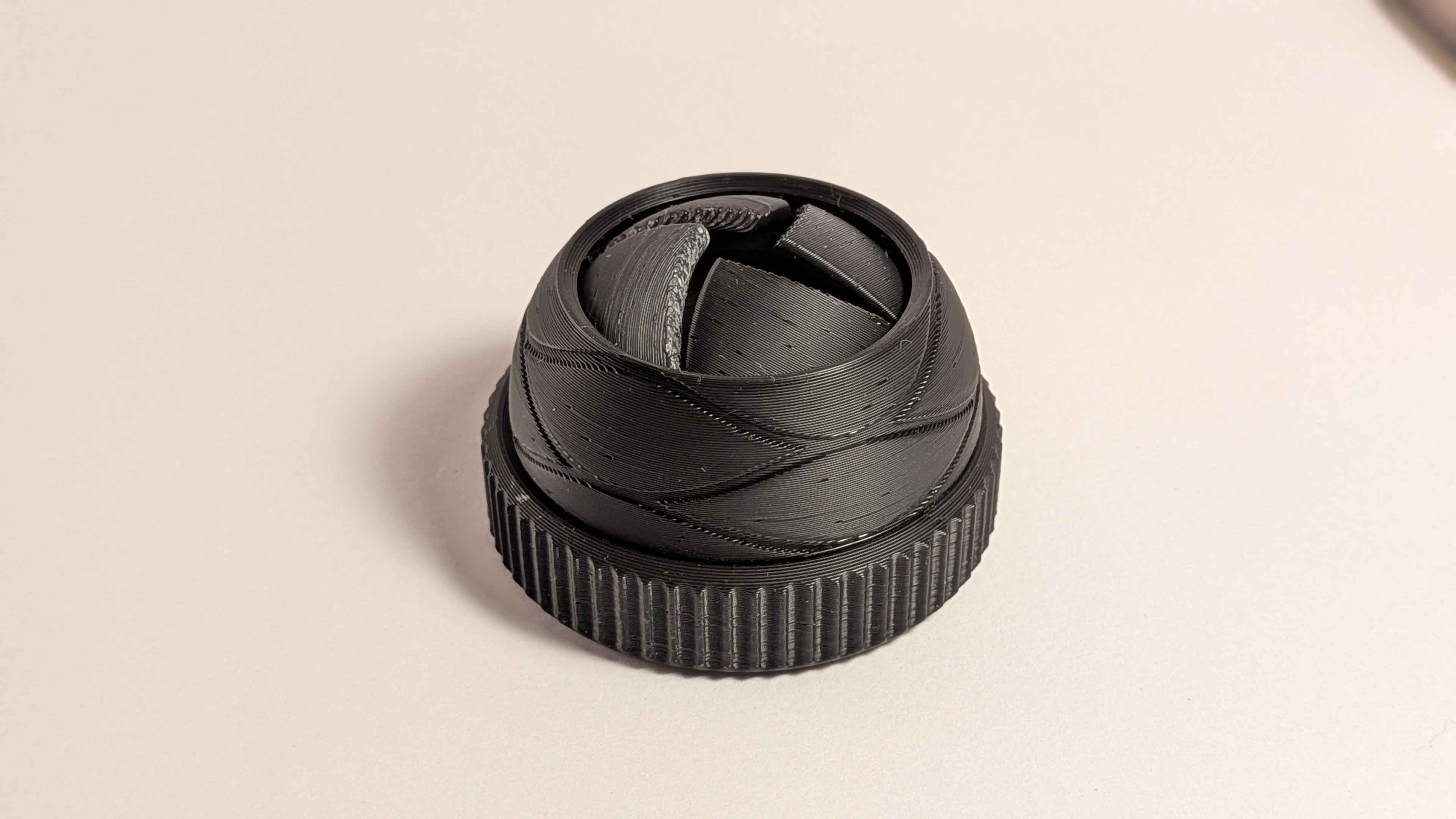 3D printed aperture mechanism toy partially open