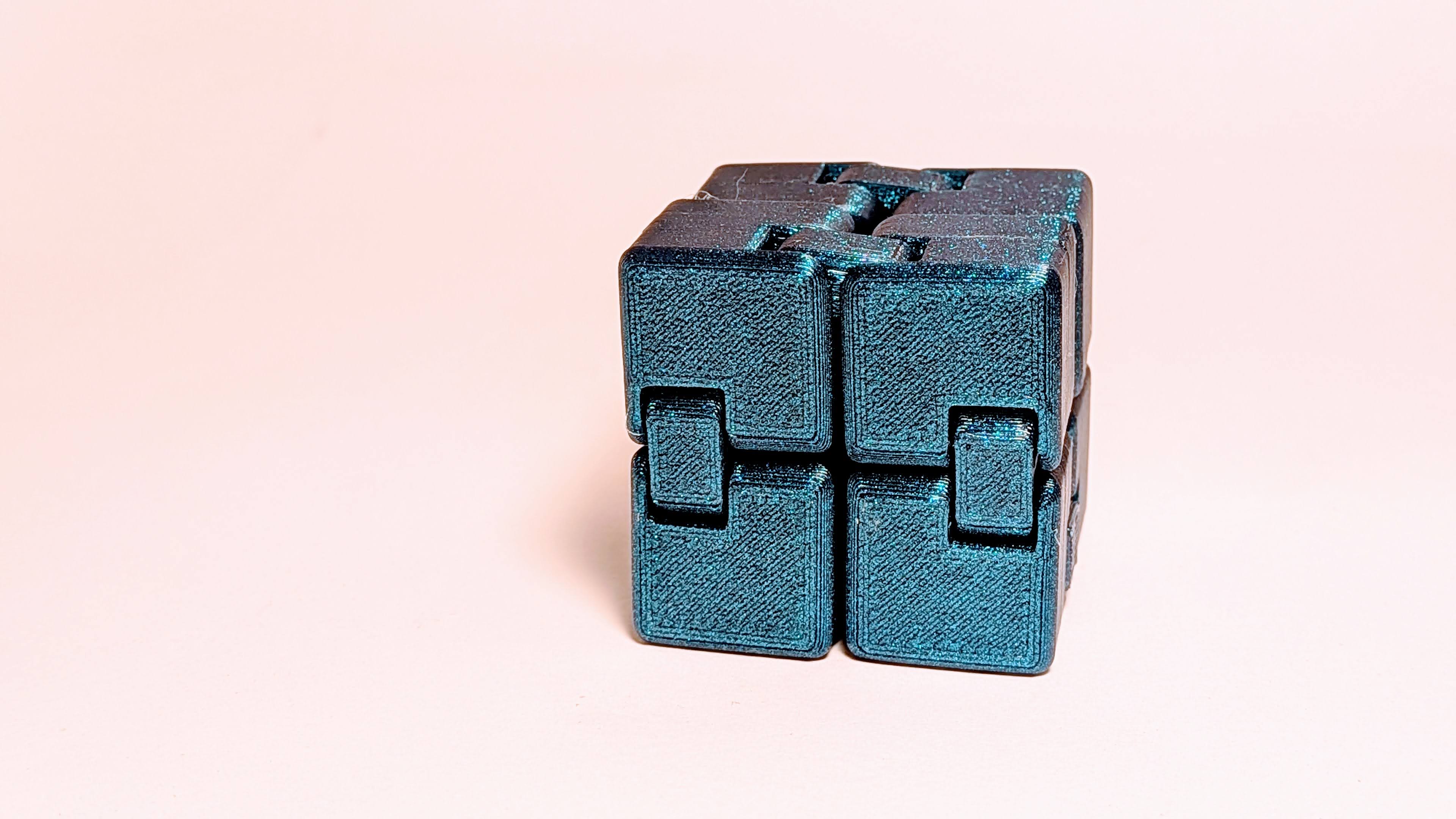 3D printed shapeshifting infinity cube fidget toy in glittery deep blue