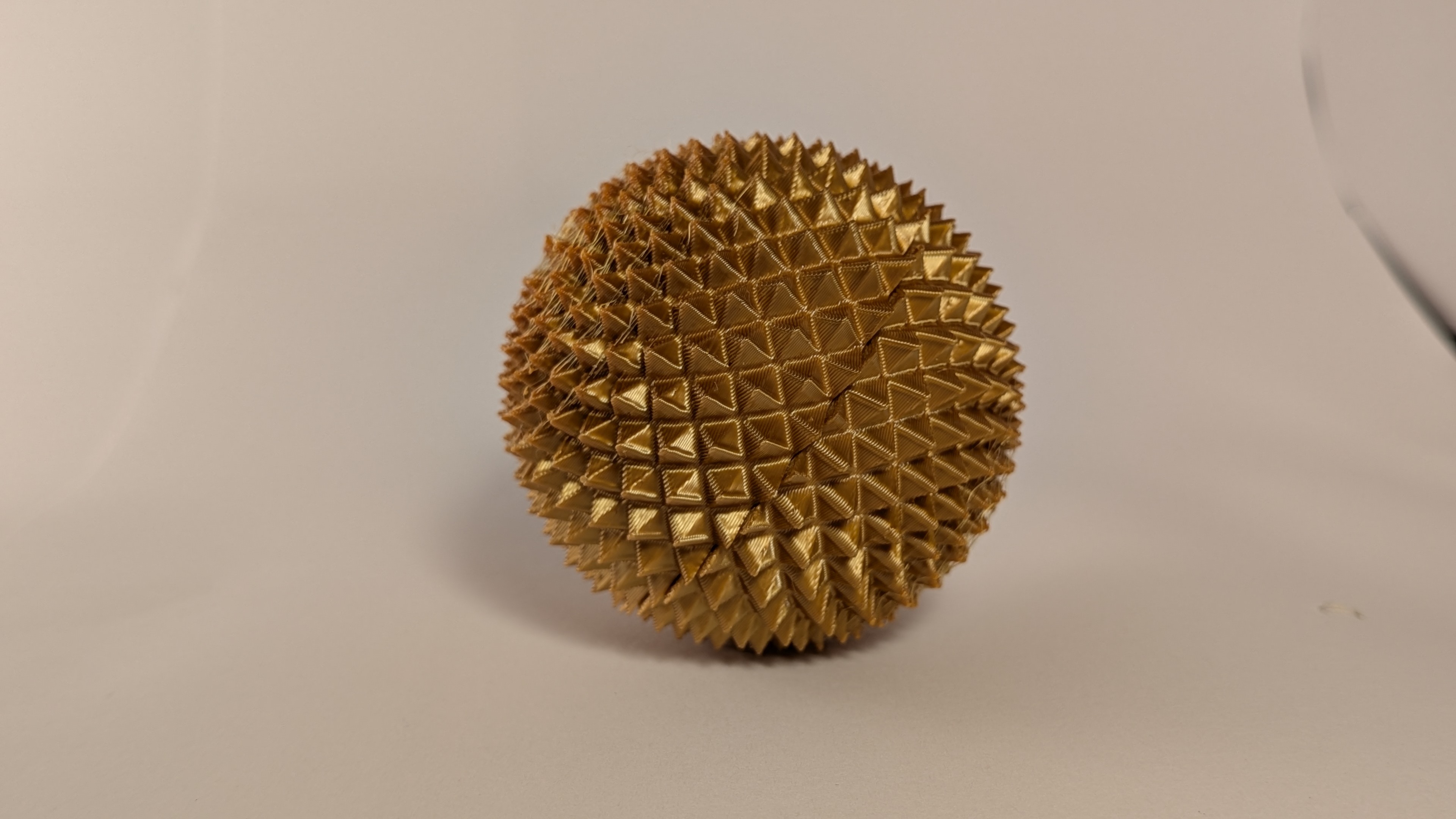 Gold 3D printed spiky fidget sphere